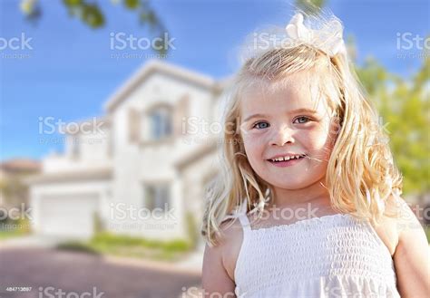 Cute Smiling Girl Playing In Front Yard Stock Photo Download Image