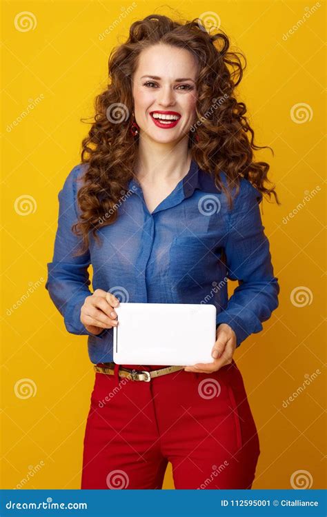 Happy Young Woman Isolated On Yellow Background With Tablet Pc Stock
