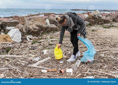 Young Girl Picking Up Trash From The Beach Stock Photo Image Of