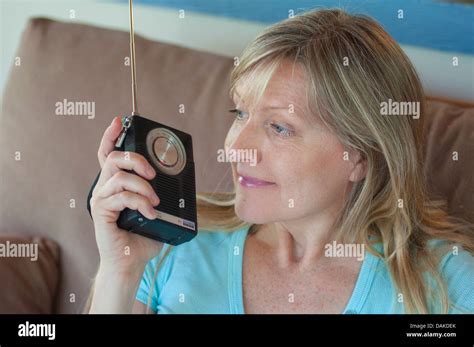 Woman Listening To Transistor Radio Stock Photo Alamy