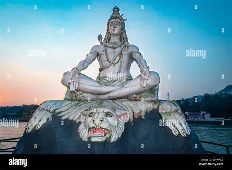 Hindu God Lord Shiva Statue In Meditation Posture With Dramatic Sky At