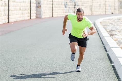 Focused Strong Sporty Man Running Fast On Road Photo Free Download