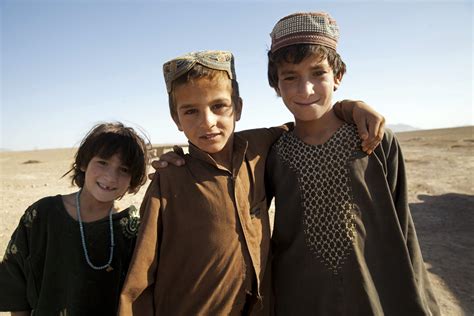 Afghan Children Pose For A Photograph While Watching Us Marines And