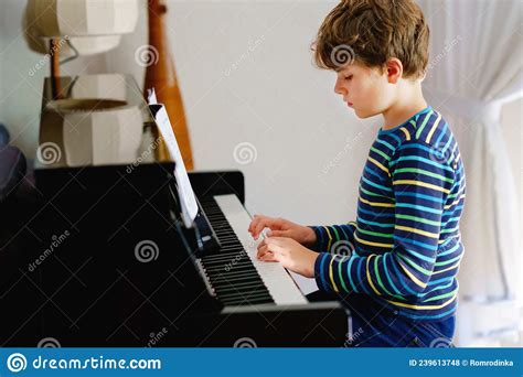 Beautiful Little Kid Boy Playing Piano In Living Room Child Having Fun