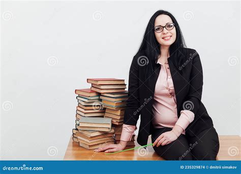 A Woman Brunette In A Business Suit Teacher With Stacks Of Books Stock