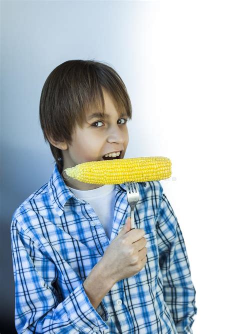 Teenager Boy In Plaid Shirt Eating Boiled Corn Cob Stock Image Image