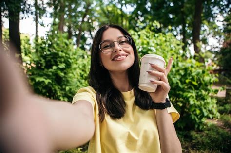 Premium Photo Woman Drink Coffee Outside And Taking Selfie