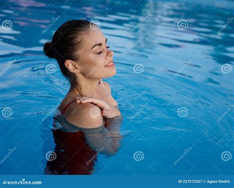 Pretty Woman With Closed Eyes In Swimsuit In Luxury Pool Stock Image