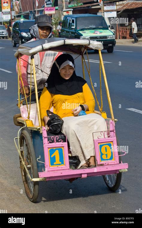 Young Muslim Woman Riding In A Becak Or Bicycle Rickshaw In Makassar On