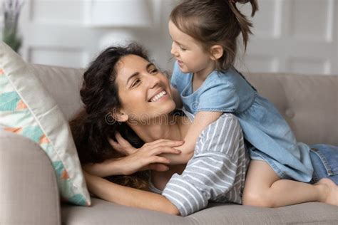 Close Up Smiling Mother And Little Daughter Cuddling On Couch Stock Image Image Of
