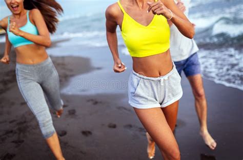 Group Of Sport People Jogging On The Beach Stock Image Image Of