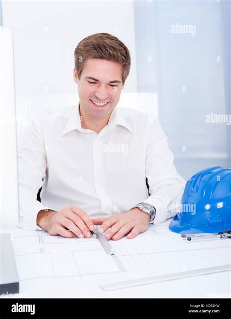 Portrait Of A Young Architect Drawing Plan On Blueprint Stock Photo Alamy