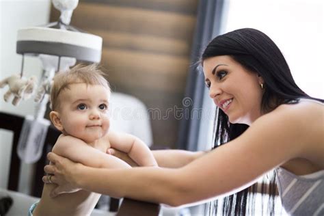 Mother Putting Baby To Sleep At The Crib Stock Photo Image Of Infant