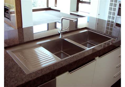 A modern stainless steel kitchen sink is usually a rectangular deep basin with a sleek faucet. Stainless Steel Kitchen Sinks from Britex