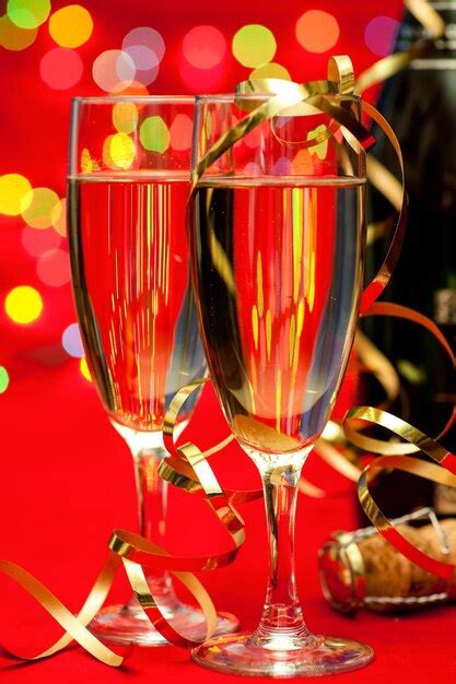 Premium Photo Two Glasses Of Champagne With Blured Lights In