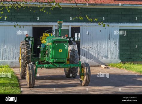 Vintage John Deere Tractor In Front Of An Old Barn Stock Photo Alamy