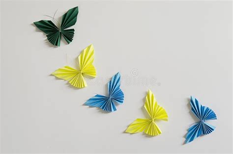 Blue And Yellow Origami Butterflies On White Background Stock Photo