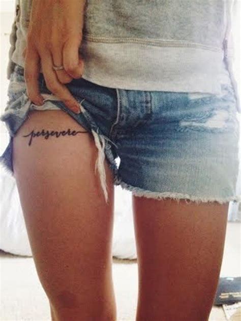 A Woman With A Tattoo On Her Thigh And The Word Happiness Written In