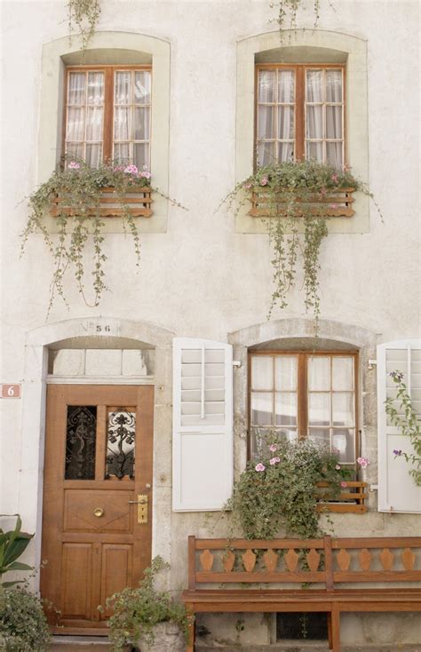 Heavy wood features, including doors, ceiling beams and porch supports, contrast with the smooth surface of the exterior. Image result for cream stucco house white windows boxes ...