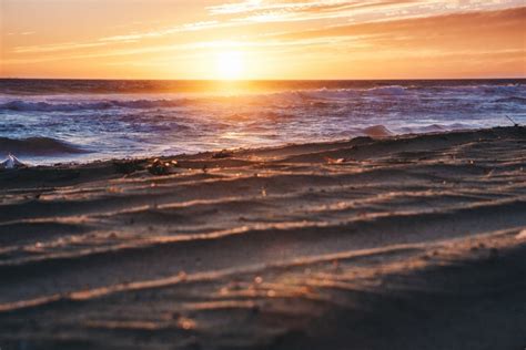 Wallpaper Id 260263 A Sunset Reflecting Off The Cresting Waves Over
