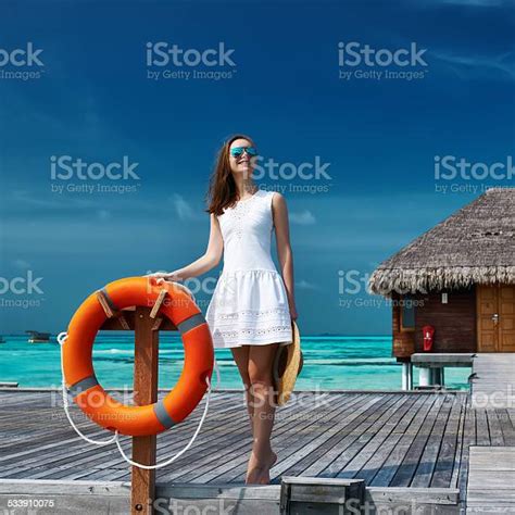 Woman On A Beach Jetty At Maldives Stock Photo Download Image Now