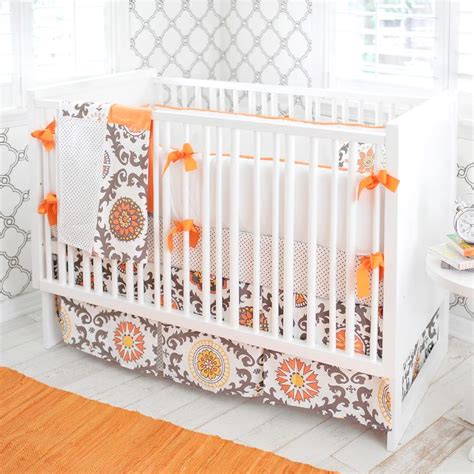 The three piece set includes a bumper, crib sheet & skirt. Gray and Orange Contemporary Nursery Bedding