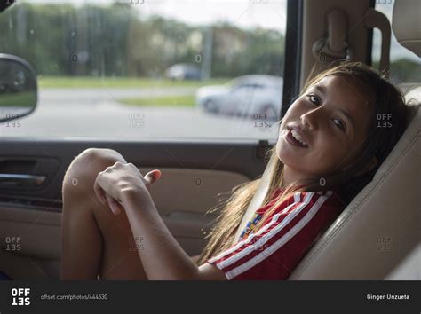 Babe Girl Lounging In Car Seat Stock Photo OFFSET