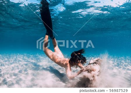 Naked Woman Free Diver With Sand Over Sandy Sea Stock Photo