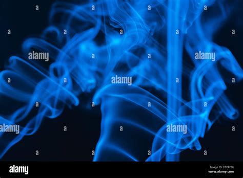 Blue Abstract Shaped Smoke Against Black Background Abstract