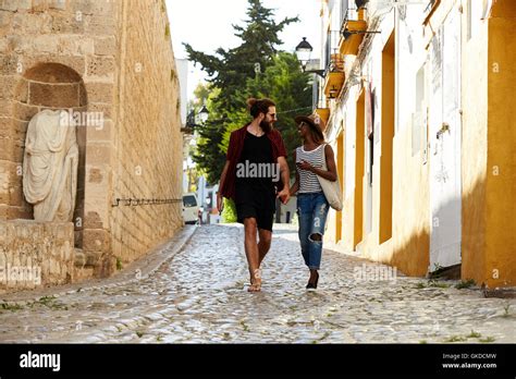 Couple On Holiday Walking In Ibiza Streets Talking Stock Photo Alamy