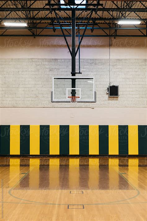 Basketball Hoop In Gymnasium By Stocksy Contributor Raymond Forbes