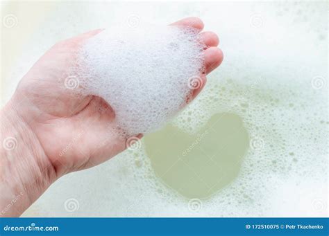 Soap Suds On A Person S Hand On A Background Of Soap Suds The Concept