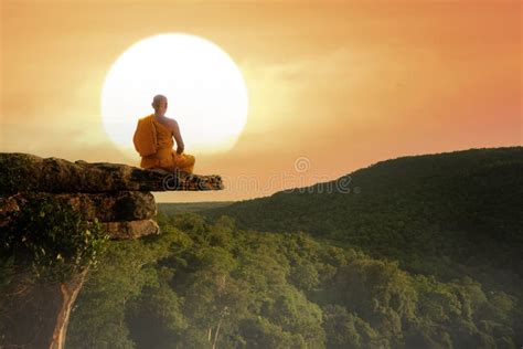 Buddhist Monk In Meditation At Beautiful Sunset Or Sunrise Background