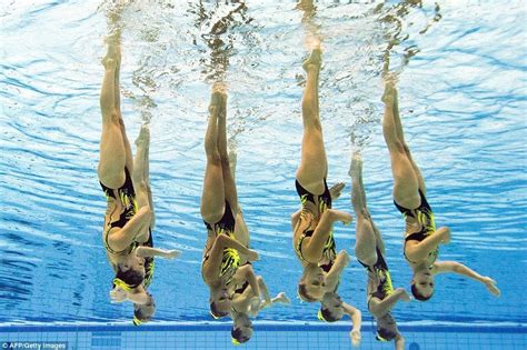Underwater Photographs Show Synchronised Swimmers Competing At