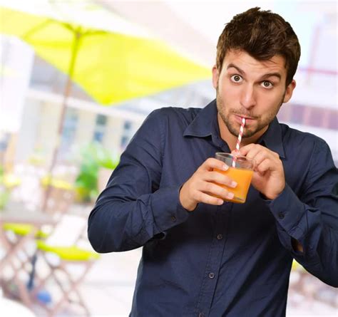 Man Sipping Juice Through Straw — Stock Photo © Coolfonk 11658376