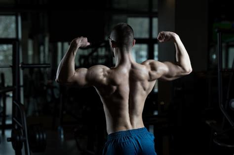 Premium Photo Nerd Man Standing Strong In Gym