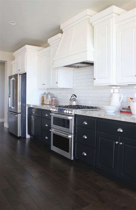 White modern kitchen cabinets offer black hardware along with gray backsplash, and dark wood floor. Having A Moment: Navy and White Kitchen Cabinets - Lauren ...