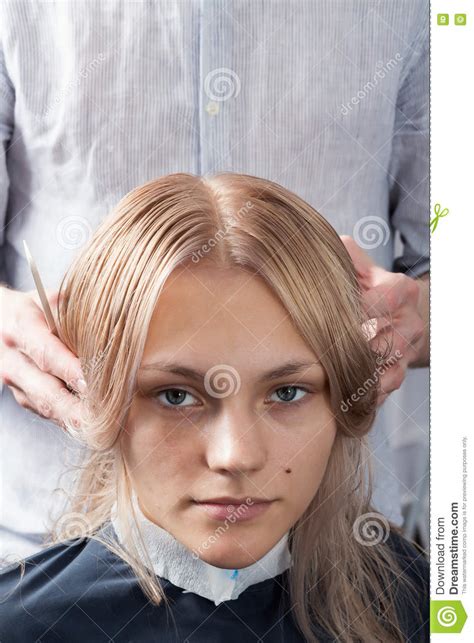 Beautiful Blonde Girl Having Her Haircut In Hairdressing