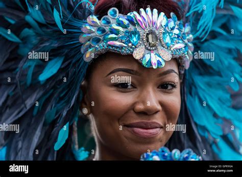 Black Beautiful Afro Caribbean Woman Dressed In A Blue Feather Headdress At The Notting Hill