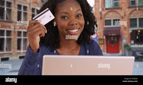 Smart Financially Independent Black Woman Holding Up Credit Card And