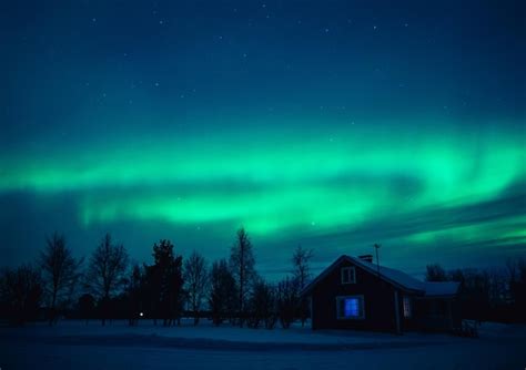Premium Photo Northern Lights Aurora Borealis Over Snowedin Cottage