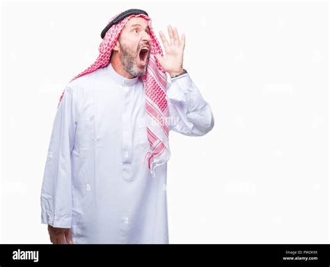 senior arab man wearing keffiyeh over isolated background shouting and screaming loud to side