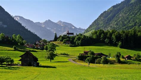 Flueli Switzerland Scenery Houses Mountains Grasslands Trees Hd
