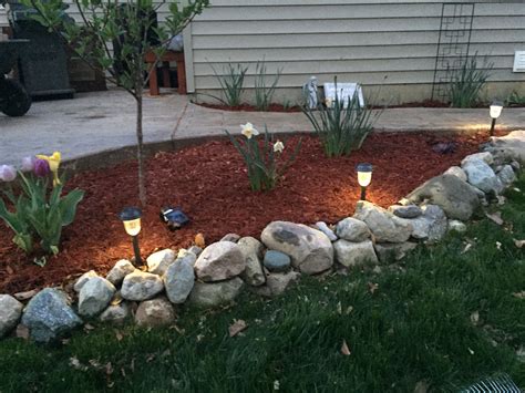 Great flower bed design around a stamped concrete patio ...