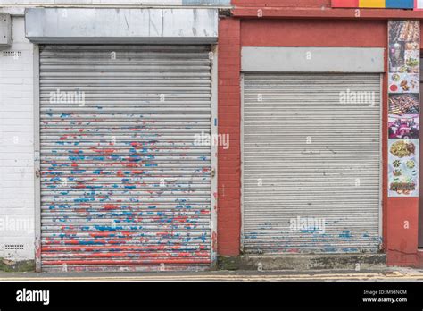 Battered Closed Roller Shutter Door With Paint Peeling Off Metaphor