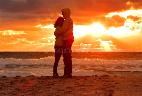 Couple Man And Woman Hugging In Love Staying On Beach Seaside With Sunset Scenery Royalty Free