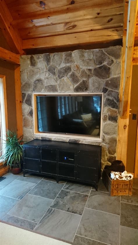 Creating a beautiful electric fireplace and tv stand. stone veneer fireplace in a Horseshoe Valley home adds