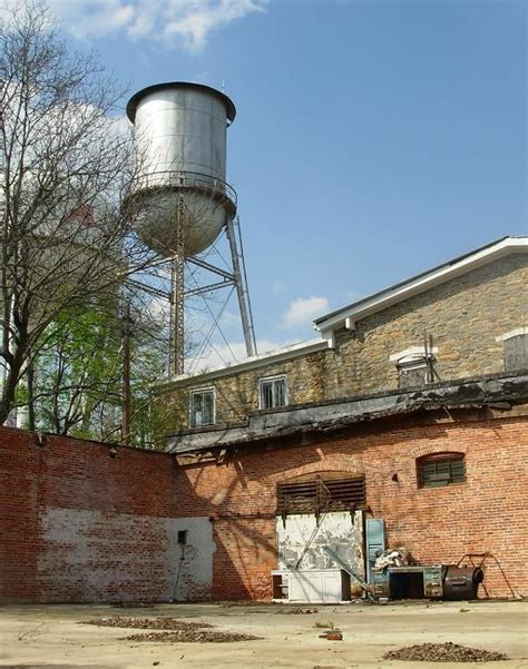 An Old Brick Building With A Water Tower In The Background