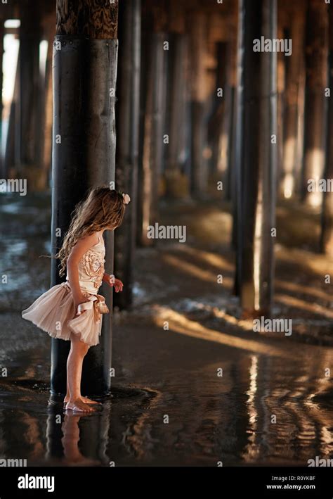 Girl Under The Pier Stock Photo Alamy