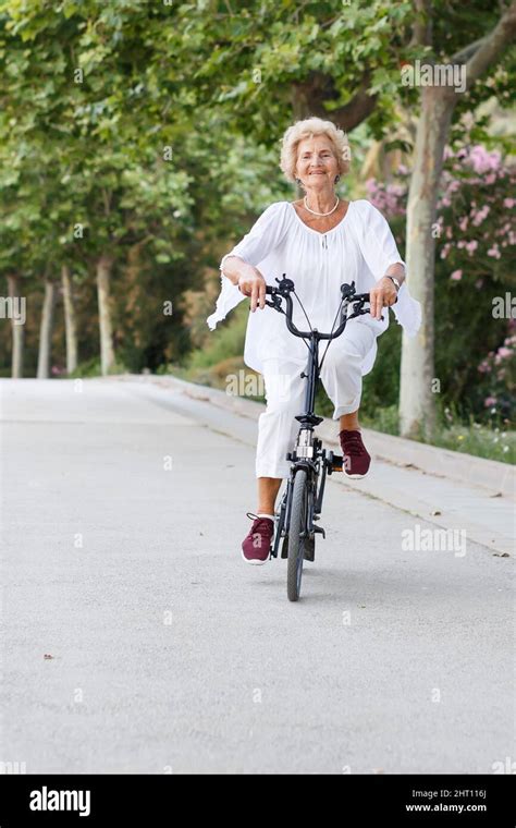 Mature Woman Cycling Stock Photo Alamy